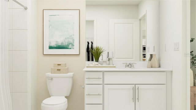 bathroom with toilet and vanity