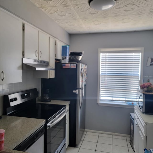 11511 113th St Unit 5C, Largo, FL 33778 - kitchen featuring appliances with stainless steel finishes, under cabinet range hood, white cabinetry, and plenty of natural light