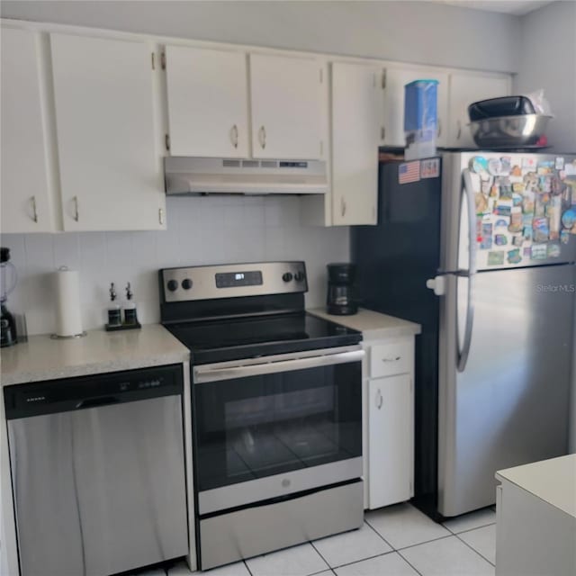 11511 113th St Unit 5C, Largo, FL 33778 - kitchen featuring appliances with stainless steel finishes, under cabinet range hood, light countertops, and light tile patterned flooring
