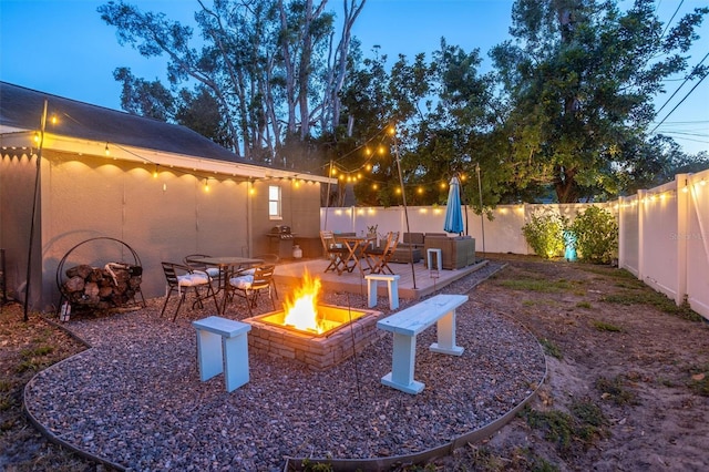 3245 Freemont Ter S, Saint Petersburg, FL 33712 - fenced backyard featuring a fire pit and a patio