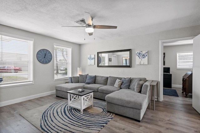3245 Freemont Ter S, Saint Petersburg, FL 33712 - living area with a ceiling fan, wood finished floors, a textured ceiling, and baseboards
