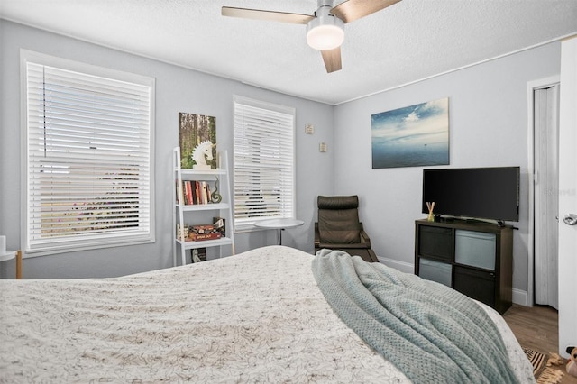 3245 Freemont Ter S, Saint Petersburg, FL 33712 - bedroom with wood finished floors, baseboards, ceiling fan, and a textured ceiling