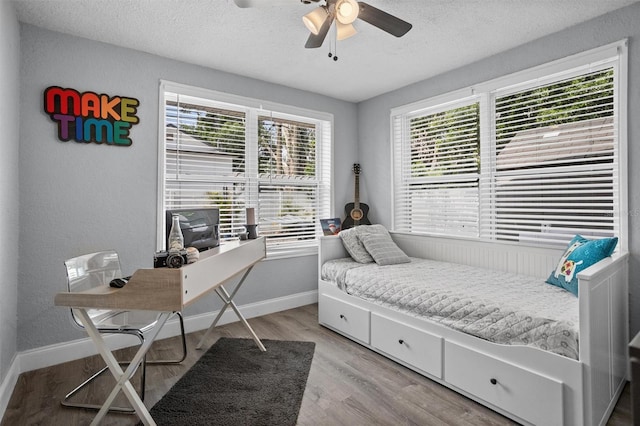 3245 Freemont Ter S, Saint Petersburg, FL 33712 - bedroom featuring light wood-style floors, a textured ceiling, baseboards, an office area, and a ceiling fan