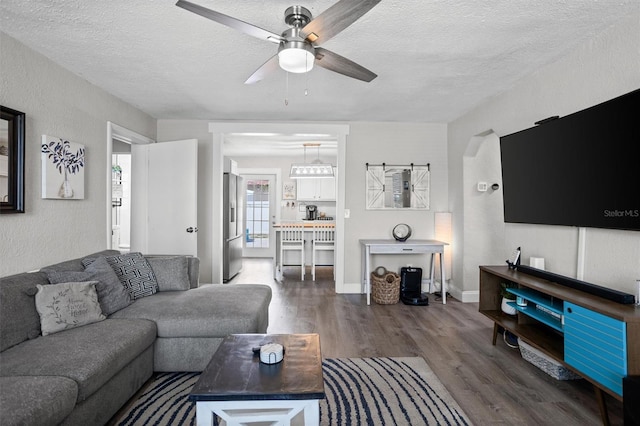 3245 Freemont Ter S, Saint Petersburg, FL 33712 - living area featuring wood finished floors, a ceiling fan, a textured ceiling, and a textured wall