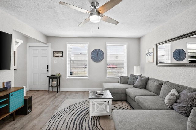 3245 Freemont Ter S, Saint Petersburg, FL 33712 - living area featuring a ceiling fan, wood finished floors, a textured ceiling, and a textured wall