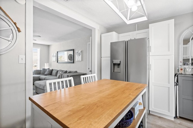 3245 Freemont Ter S, Saint Petersburg, FL 33712 - dining room featuring light wood-type flooring and a textured ceiling