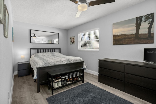 3245 Freemont Ter S, Saint Petersburg, FL 33712 - bedroom with wood finished floors, baseboards, a textured ceiling, and a ceiling fan