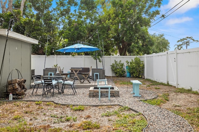 3245 Freemont Ter S, Saint Petersburg, FL 33712 - fenced backyard with a patio area, outdoor dining space, and an outdoor fire pit