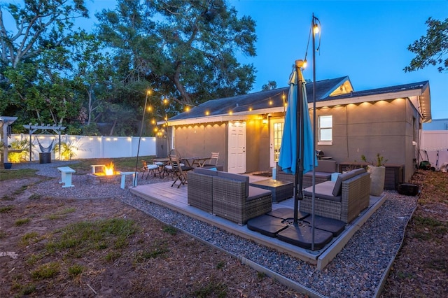 3245 Freemont Ter S, Saint Petersburg, FL 33712 - back of property with an outdoor living space with a fire pit, fence, and a patio area