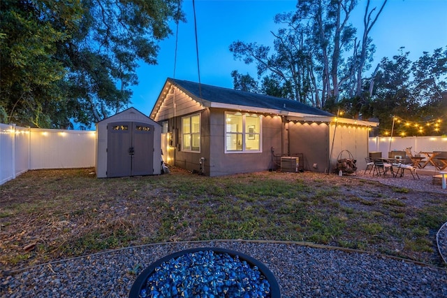 3245 Freemont Ter S, Saint Petersburg, FL 33712 - back of property with a fenced backyard, central AC, a shed, and an outbuilding