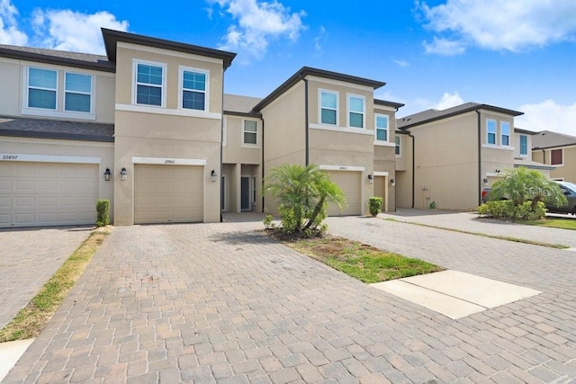 29901 Southwell Ln, Wesley Chapel, FL 33543 - view of front of property featuring an attached garage, stucco siding, and driveway