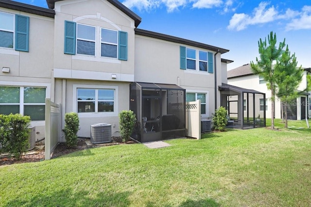 29901 Southwell Ln, Wesley Chapel, FL 33543 - back of property featuring a sunroom, central AC, stucco siding, and a yard