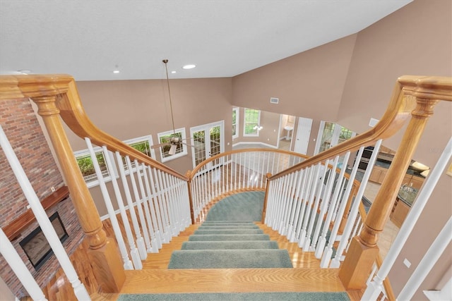 12002 Hope Ln, Tampa, FL 33618 - stairway featuring high vaulted ceiling, a fireplace, and recessed lighting