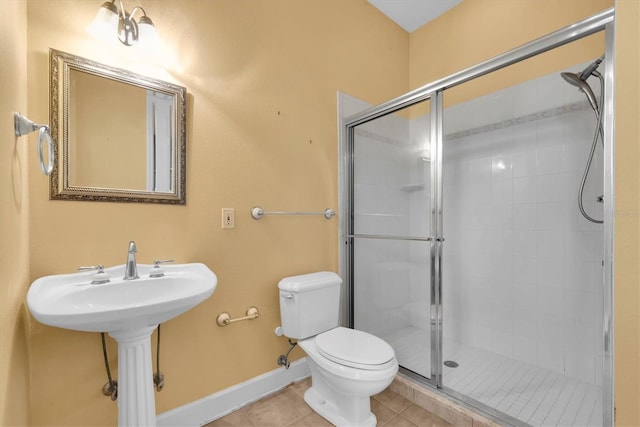 12002 Hope Ln, Tampa, FL 33618 - full bathroom featuring tile patterned flooring, a shower stall, toilet, and baseboards
