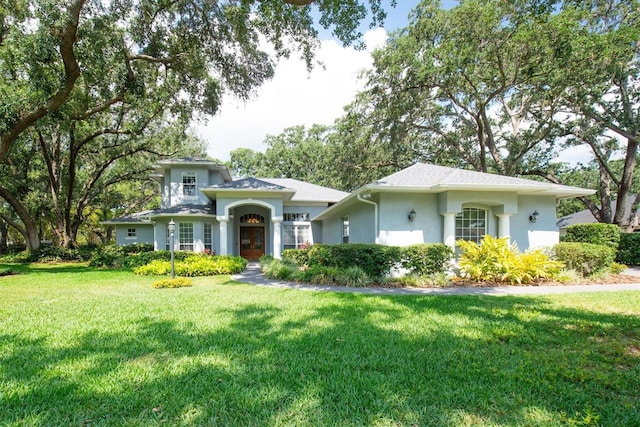 12002 Hope Ln, Tampa, FL 33618 - view of front of property featuring stucco siding, a front yard, and french doors