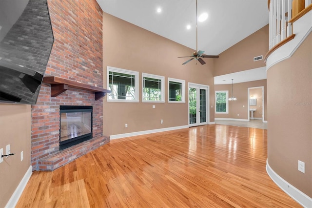 12002 Hope Ln, Tampa, FL 33618 - unfurnished living room with wood finished floors, baseboards, and high vaulted ceiling