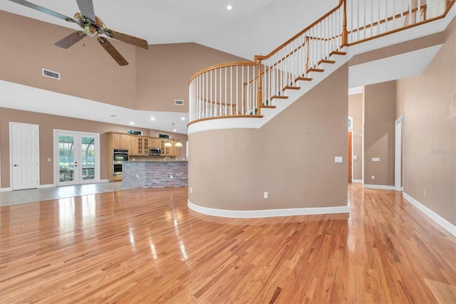 12002 Hope Ln, Tampa, FL 33618 - unfurnished living room with a ceiling fan, high vaulted ceiling, light wood finished floors, baseboards, and recessed lighting