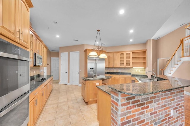 12002 Hope Ln, Tampa, FL 33618 - kitchen with a sink, appliances with stainless steel finishes, a kitchen island with sink, backsplash, and recessed lighting