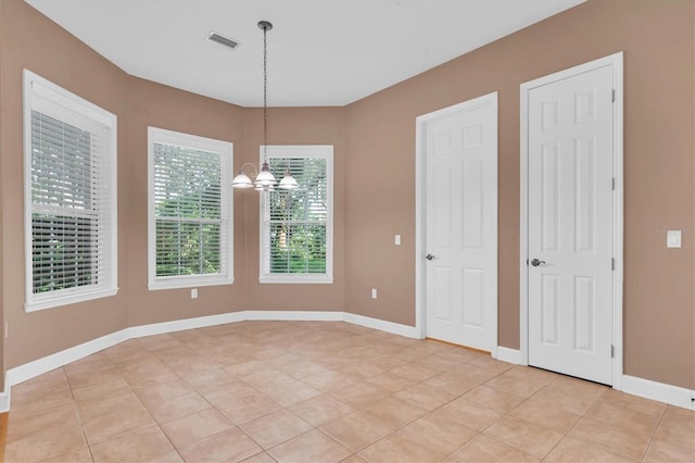 12002 Hope Ln, Tampa, FL 33618 - unfurnished dining area with a chandelier, light tile patterned floors, and baseboards