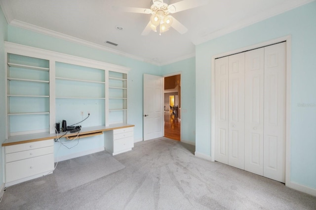 12002 Hope Ln, Tampa, FL 33618 - unfurnished bedroom with ornamental molding, light carpet, a desk, baseboards, and a closet