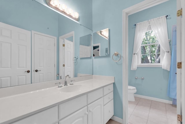 12002 Hope Ln, Tampa, FL 33618 - bathroom featuring baseboards, tile patterned floors, vanity, and toilet