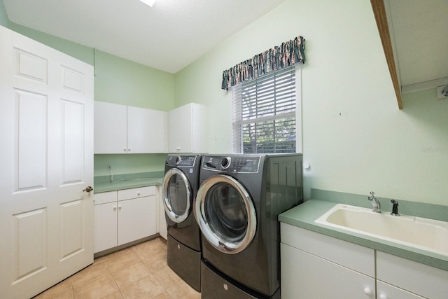 12002 Hope Ln, Tampa, FL 33618 - washroom featuring independent washer and dryer, cabinet space, and light tile patterned floors