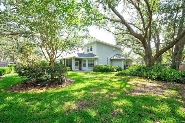 12002 Hope Ln, Tampa, FL 33618 - view of front of home with a sunroom, stucco siding, and a chimney