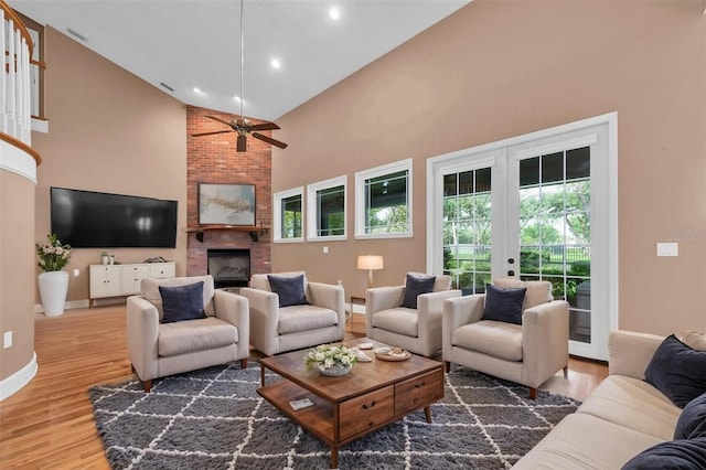 12002 Hope Ln, Tampa, FL 33618 - living area featuring high vaulted ceiling, french doors, baseboards, a brick fireplace, and wood finished floors