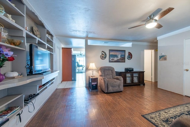 8305 75th Pl, Seminole, FL 33777 - living area with a ceiling fan and wood finished floors