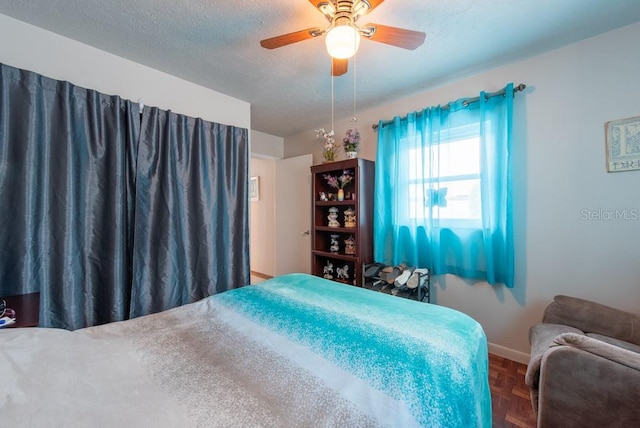 8305 75th Pl, Seminole, FL 33777 - bedroom with baseboards, a textured ceiling, and a ceiling fan