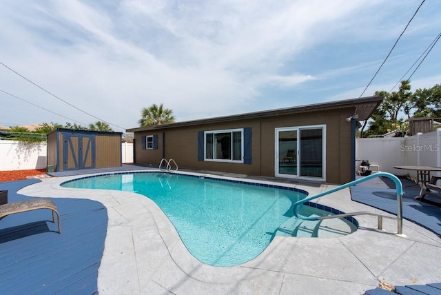 8305 75th Pl, Seminole, FL 33777 - view of pool featuring a storage unit, a fenced backyard, an outbuilding, and a patio area