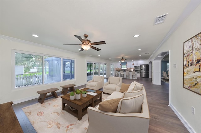 10922 Park Dr, Riverview, FL 33569 - living room with a ceiling fan, arched walkways, crown molding, recessed lighting, and wood finished floors