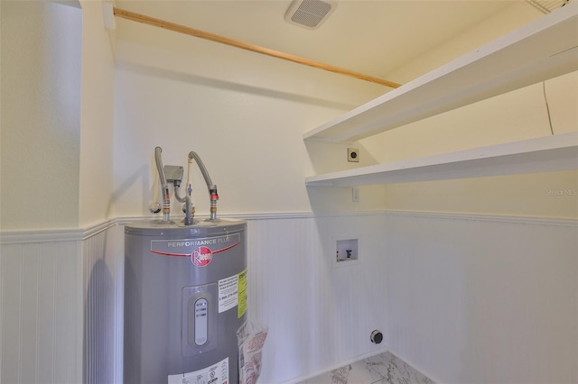 10922 Park Dr, Riverview, FL 33569 - laundry area featuring electric water heater, washer hookup, hookup for an electric dryer, a wainscoted wall, and marble finish flooring