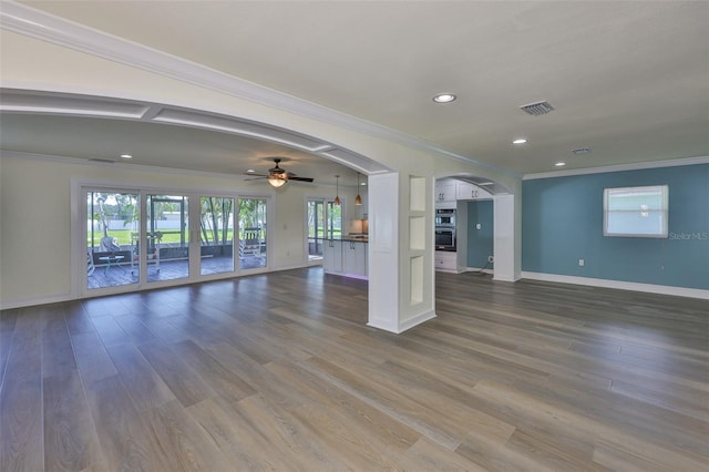 10922 Park Dr, Riverview, FL 33569 - unfurnished living room with arched walkways, ornamental molding, dark wood-type flooring, ceiling fan, and recessed lighting