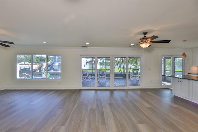10922 Park Dr, Riverview, FL 33569 - unfurnished living room featuring ceiling fan, plenty of natural light, dark wood-style flooring, ornamental molding, and recessed lighting