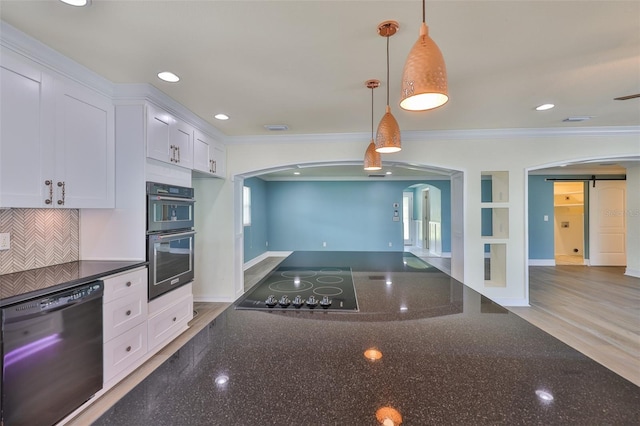 10922 Park Dr, Riverview, FL 33569 - kitchen featuring black appliances, arched walkways, ornamental molding, white cabinets, and dark stone counters