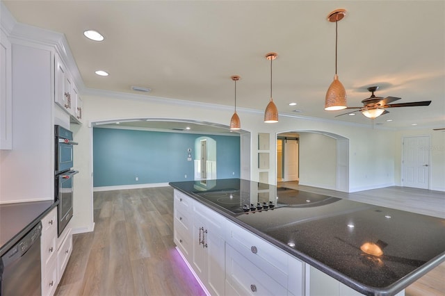 10922 Park Dr, Riverview, FL 33569 - kitchen featuring arched walkways, open floor plan, dishwasher, light wood-type flooring, and white cabinetry