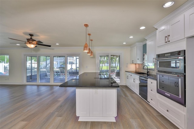 10922 Park Dr, Riverview, FL 33569 - kitchen with double oven, black dishwasher, open floor plan, white cabinets, and dark countertops