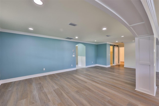 10922 Park Dr, Riverview, FL 33569 - spare room featuring arched walkways, ornamental molding, recessed lighting, and wood finished floors