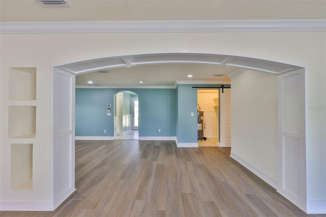 10922 Park Dr, Riverview, FL 33569 - spare room featuring arched walkways, crown molding, recessed lighting, electric water heater, and wood finished floors