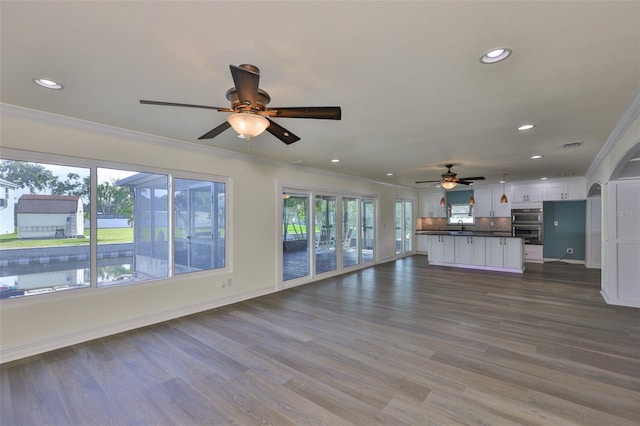 10922 Park Dr, Riverview, FL 33569 - unfurnished living room featuring a ceiling fan, crown molding, recessed lighting, and dark wood-type flooring