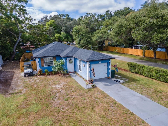 351 Hancock St, Dunedin, FL 34698 - single story home featuring a shingled roof, concrete driveway, an attached garage, and stucco siding
