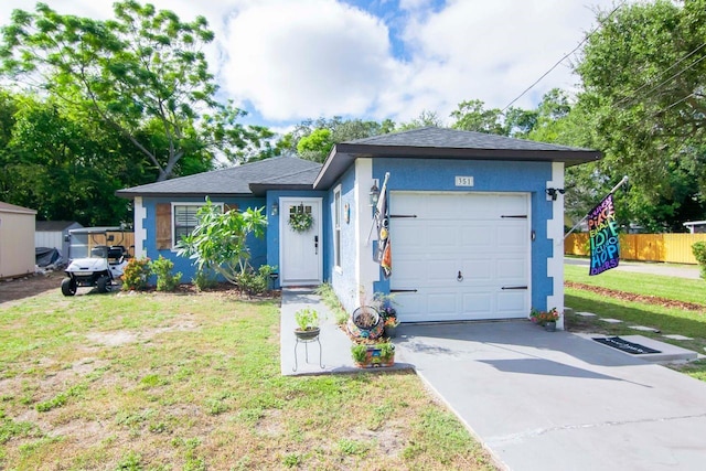 351 Hancock St, Dunedin, FL 34698 - ranch-style home featuring stucco siding, concrete driveway, and an attached garage
