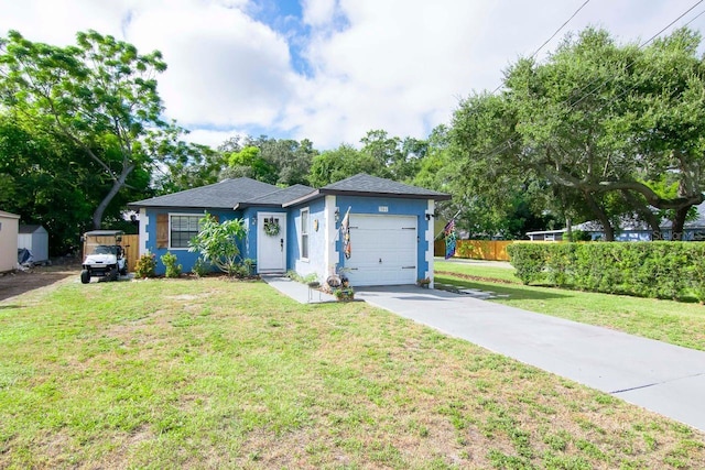 351 Hancock St, Dunedin, FL 34698 - ranch-style house with an attached garage, driveway, stucco siding, and a shingled roof