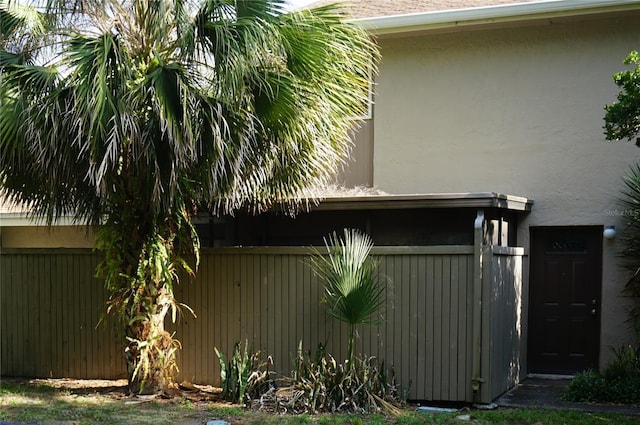 8011 Peach Dr Unit 103, Tampa, FL 33637 - view of home's exterior featuring stucco siding and fence