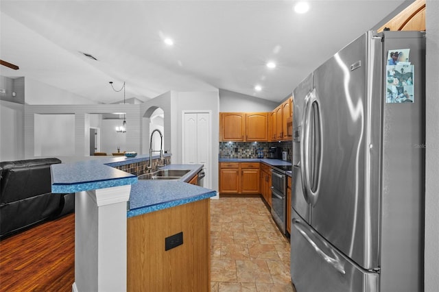 18631 Le Dauphine Pl, Lutz, FL 33558 - kitchen featuring stainless steel appliances, a sink, vaulted ceiling, open floor plan, and tasteful backsplash