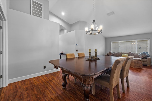 18631 Le Dauphine Pl, Lutz, FL 33558 - dining room featuring a chandelier, high vaulted ceiling, arched walkways, wood finished floors, and baseboards