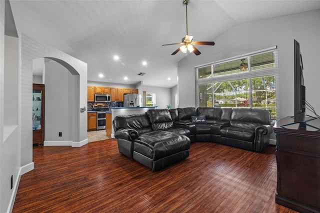 18631 Le Dauphine Pl, Lutz, FL 33558 - living room featuring arched walkways, a ceiling fan, vaulted ceiling, wood finished floors, and baseboards