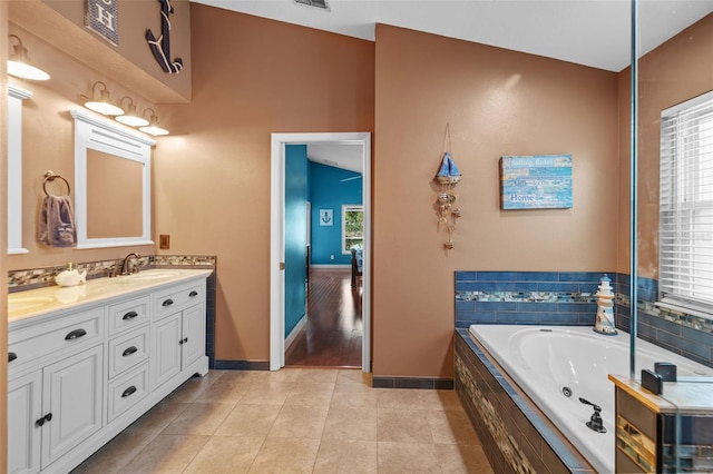 18631 Le Dauphine Pl, Lutz, FL 33558 - bathroom with baseboards, tile patterned flooring, double vanity, a jetted tub, and plenty of natural light