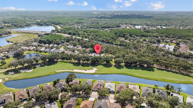 18631 Le Dauphine Pl, Lutz, FL 33558 - aerial perspective of suburban area with a golf club, a large body of water, and a forest